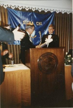 Grand Consul Robert Joseph presents Iota Omicron charter to James Purcell